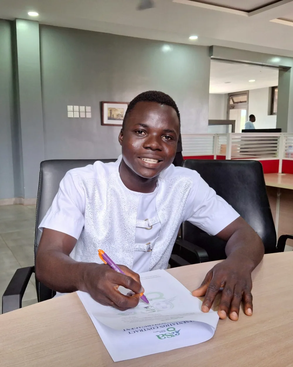 Crentsil signing a representation contract at the GFarok Sports Agency office